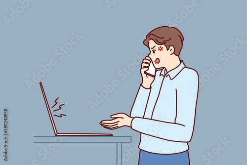 Dissatisfied manager makes phone call standing near laptop and quarreling with employees due to errors in financial report. Crazy boss angry after computer crash quarreling with support staff 
