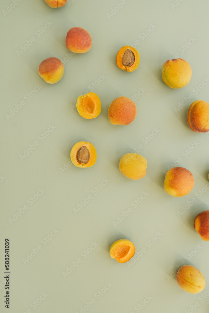 Aesthetic fruit background. Flat lay composition with peaches. Ripe juicy peaches on pastel green background. Flat lay top view. Fresh organic fruit vegan food