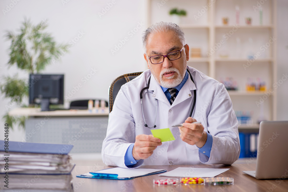 Old male doctor pharmacist in drugs synthesis concept Old male doctor pharmacist in drugs synthesis concept