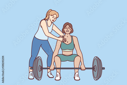 Strong athlete lifts heavy barbell under supervision of personal trainer from gym teaching ward before competition. Bodybuilding trainer supports sportswoman doing pulling exercise in fitness club