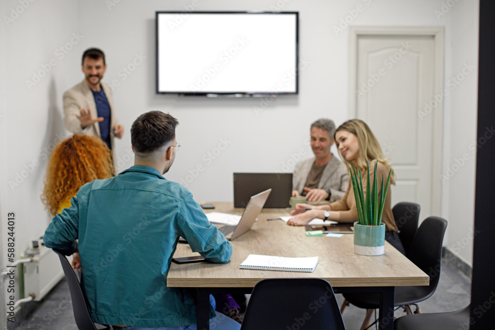 Business team on a morning briefing; business meeting and presentation in a modern office Business team on a morning briefing; business meeting and presentation in a modern office