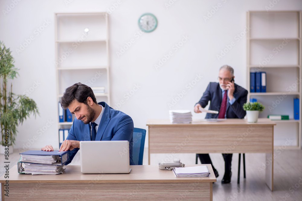 Two male colleagues working in the office Two male colleagues working in the office