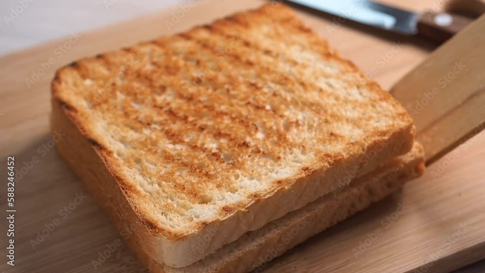 Place the toasted sandwich on a cutting board. Toast with cheese on the breakfast or snack. Place the toasted sandwich on a cutting board. Toast with cheese on the breakfast or snack.