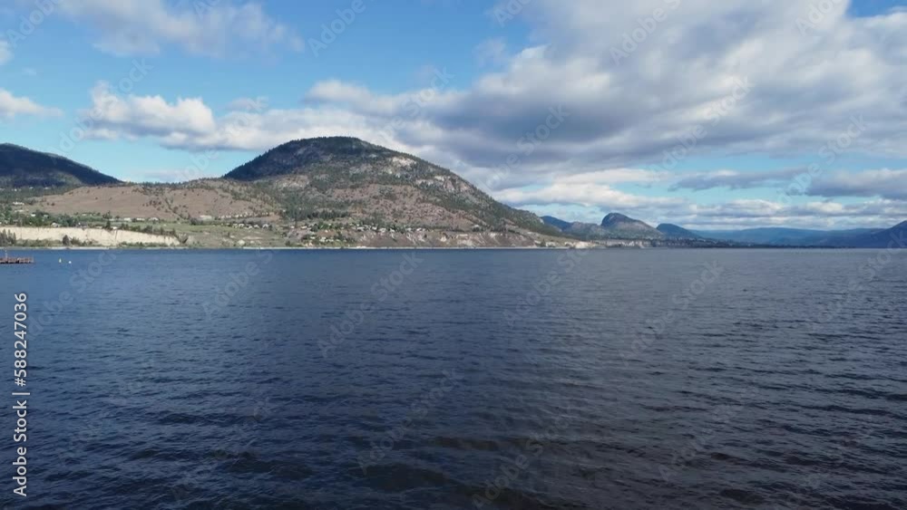 Drone flying over Okanagan Lake in Penticton, British Columbia on a sunny summer day. Drone flying over Okanagan Lake in Penticton, British Columbia on a sunny summer day.