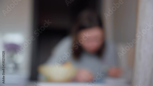 Girl eats in the kitchen at the table blurred background. Morning breakfast lunch, at home