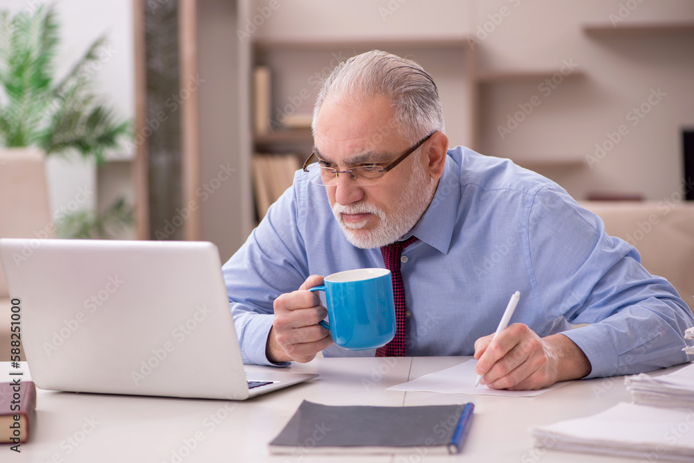 Old male employee working from home during pandemic Old male employee working from home during pandemic