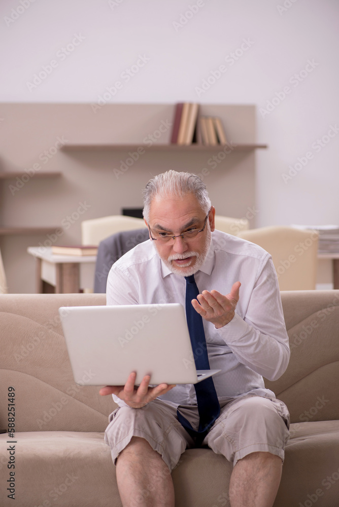 Old male employee working from home during pandemic Old male employee working from home during pandemic
