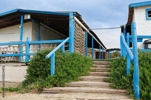 Wood Building Built on the Beach, Deserted and Desolate Beach in Winter Time © GioRez