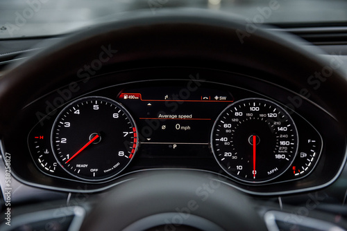Car panel with a speedometer, a tachometer, oil and gasoline levels, engine temperature. Car dashboard details. While parking and turning off the engine. Details interior closeup.
