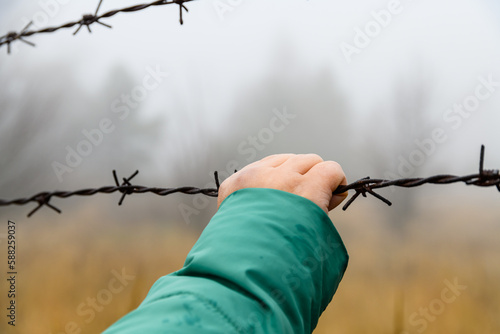 Barbed wire fence at the Chernobyl exclusion zone, Ukraine photo
