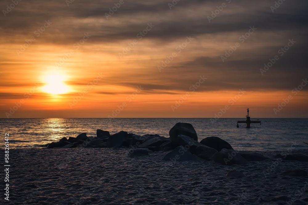 Beautiful morning seaside landscape. Cloudy sunrise over the Baltic Sea. Photo taken on the beach in Gdynia, Poland.