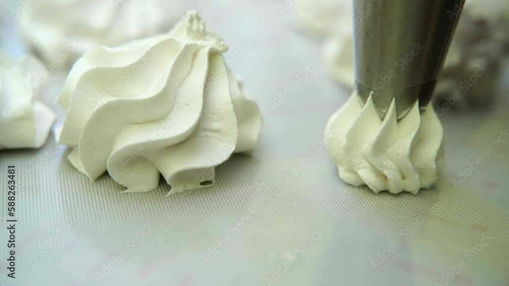 woman makes marshmallows with a pastry bag. Taken in close-up woman makes marshmallows with a pastry bag. Taken in close-up