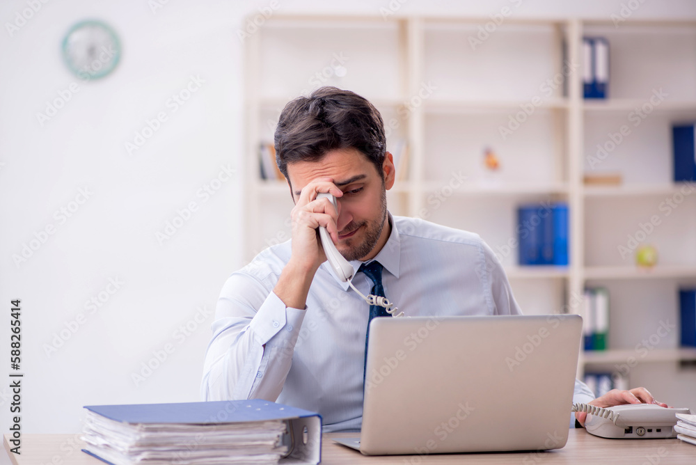 Young male employee working in the office Young male employee working in the office