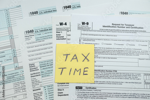 Sticker with text tax time on blank USA tax form 1040 2022