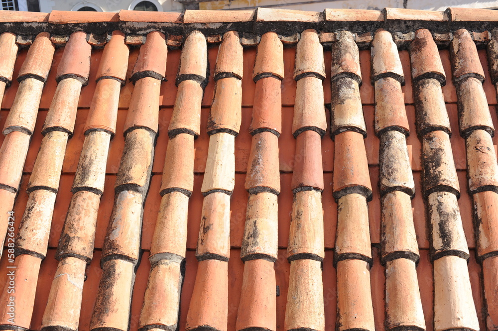 Red and orange roof tiles texture pattern on roof of an old historical building Red and orange roof tiles texture pattern on roof of an old historical building