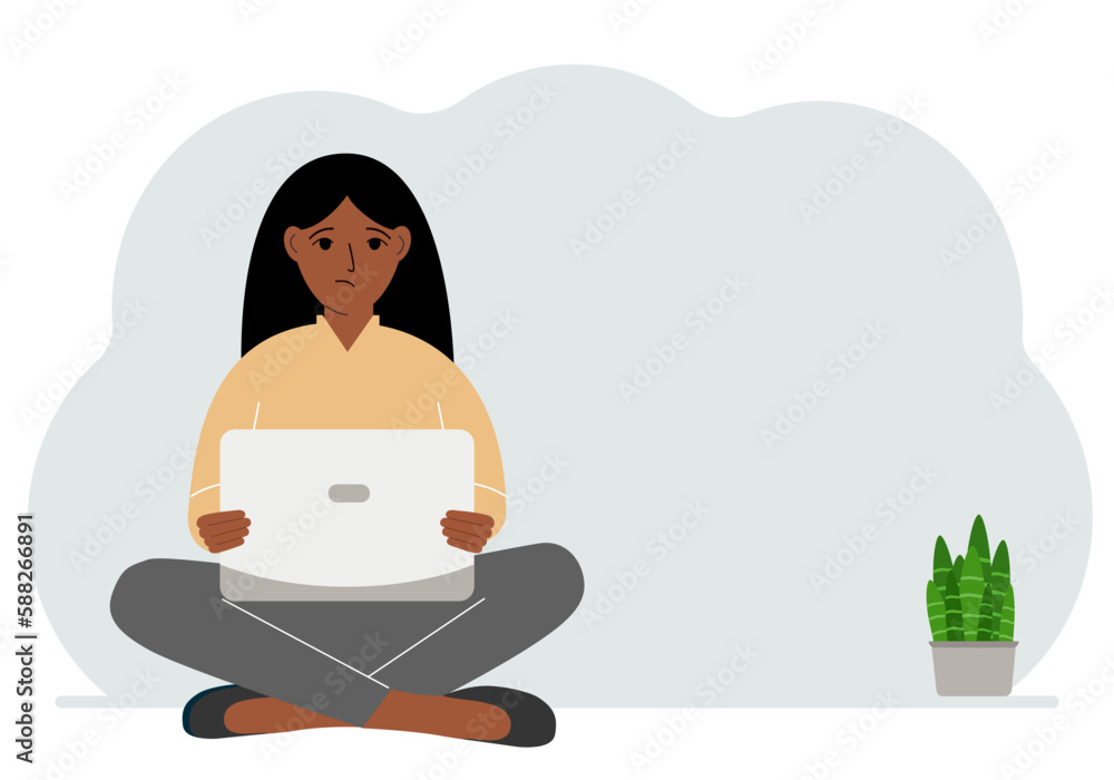 A woman sits cross-legged in his hands holding a laptop. The concept of work, education, reading, watching videos. A woman sits cross-legged in his hands holding a laptop. The concept of work, education, reading, watching videos.