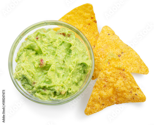 Guacamole bowl and corn chips near in it on white background. Top view. File contains clipping path.