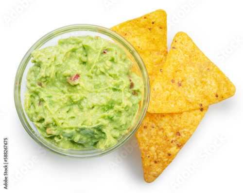 Guacamole bowl and corn chips near it on white background. Top view. File contains clipping path.