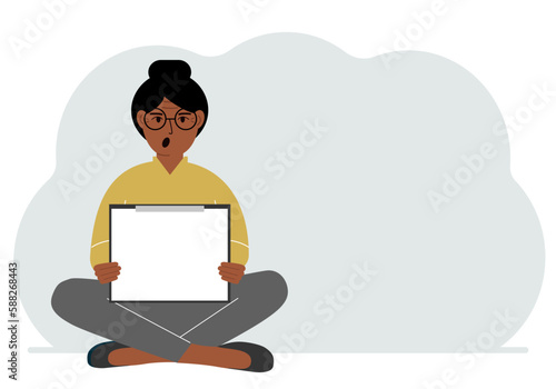 A woman sits crossing his legs and holds a clipboard with a white read sheet for the text in his hands.