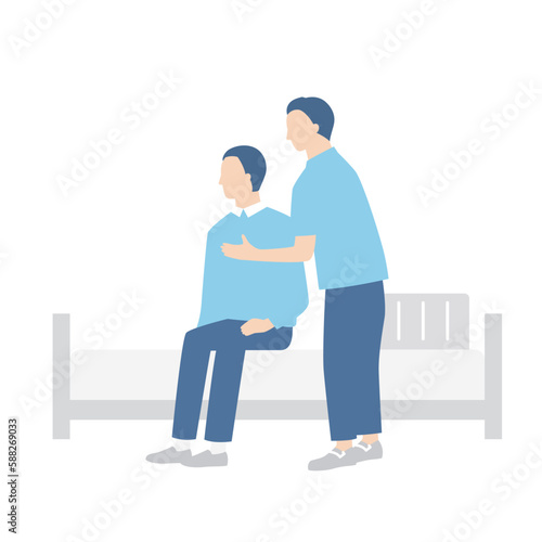 ベッドから起き上がる男性と介助する介護福祉士