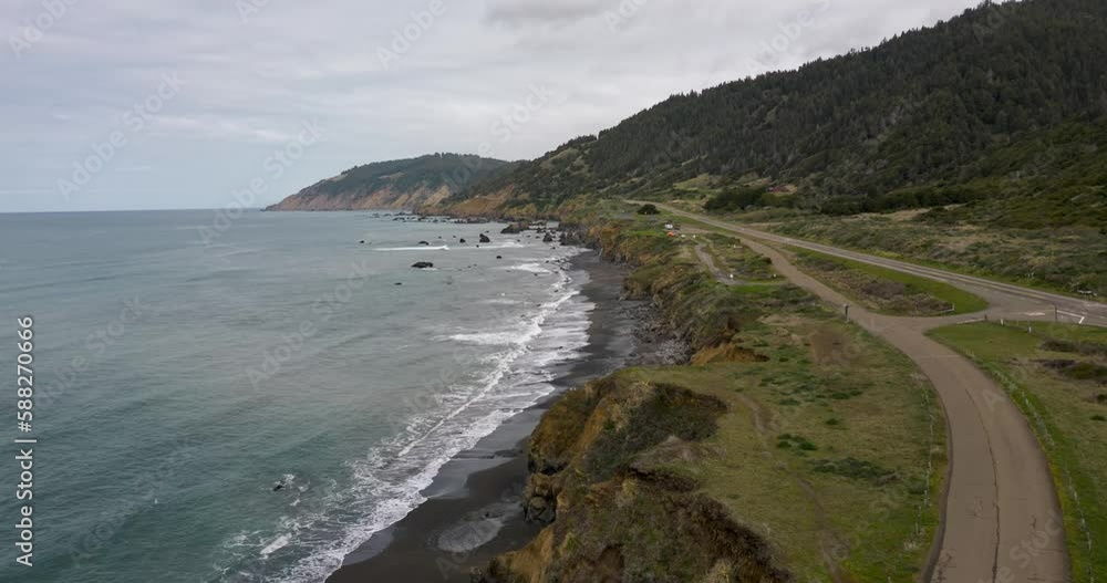 aerial time lapse of the pacific coast highway driving pass a camp ground in northern california by the coast showing waves breaking and jagged cliffs aerial time lapse of the pacific coast highway driving pass a camp ground in northern california by the coast showing waves breaking and jagged cliffs