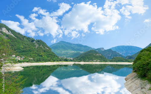 Beautiful summer scenery of Lake Corlo in Italy surrounded by the Alps.