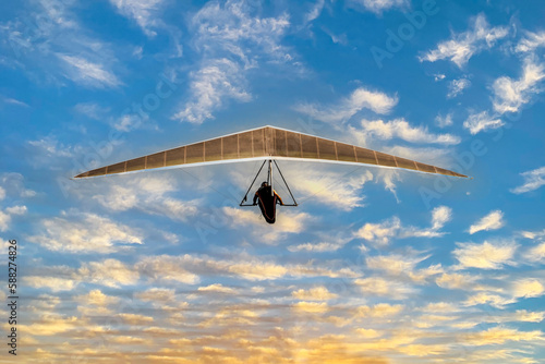 Hang glider flying alone in the sky