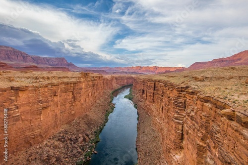 A stunning view of a rugged canyon featuring steep vertical walls of rock that form a deep