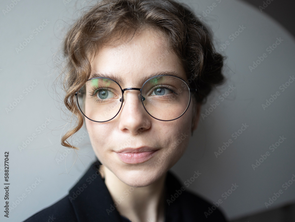 face portrait of a teenage girl 18 -19 years old, schoolgirl, college student. cute young smart woman in glasses, thinks, looks away. Real people, everyday life. Selective focus face portrait of a teenage girl 18 -19 years old, schoolgirl, college student. cute young smart woman in glasses, thinks, looks away. Real people, everyday life. Selective focus