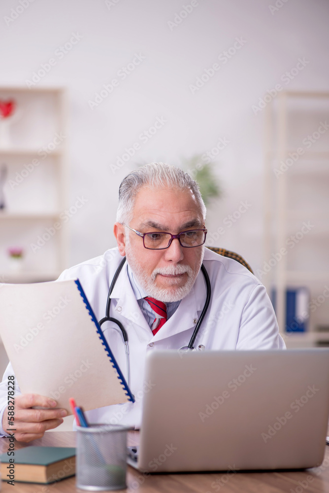 Old male doctor in telemedicine concept Old male doctor in telemedicine concept
