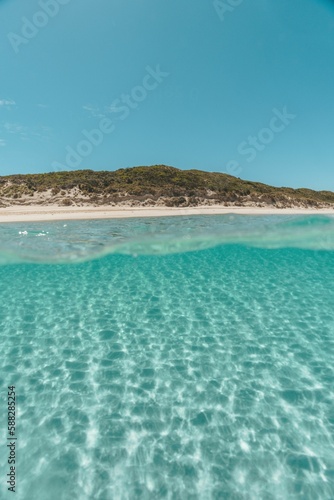 Beautiful landscape of clear water facing the sandy beach on a sunny morning