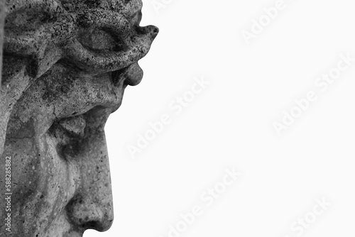 Close up profile of Jesus Christ in a crown of thorns against white background. Fragment of an ancient statue.