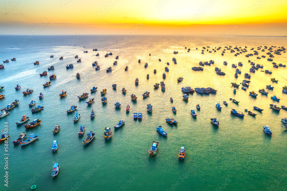 Aerial view of Mui Ne fishing village in sunset sky with hundreds of boats anchored to avoid storms, this is a beautiful bay in central Vietnam