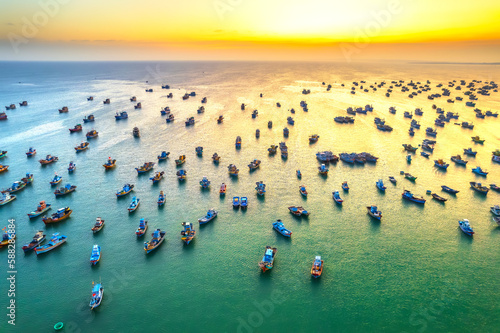Aerial view of Mui Ne fishing village in sunset sky with hundreds of boats anchored to avoid storms, this is a beautiful bay in central Vietnam © huythoai