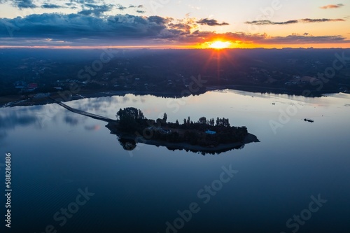 Bird's-eye view of the Aucar Island connecting with land with a wooden walkway during the sunset photo