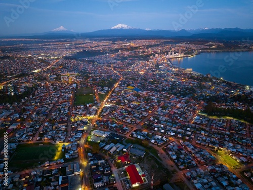 Bird's-eye view of the Puerto Montt city in the evening lights © Mav Drone/Wirestock Creators