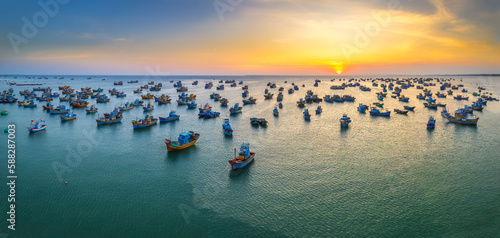 Aerial view of Mui Ne fishing village in sunset sky with hundreds of boats anchored to avoid storms, this is a beautiful bay in central Vietnam