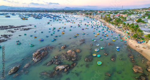 Aerial view of Mui Ne fishing village in the morning with hundreds of boats anchored to avoid storms, this is a beautiful bay in central Vietnam © huythoai