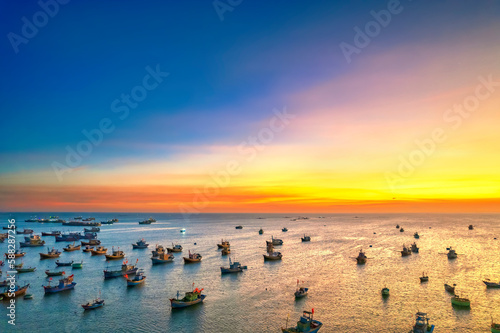 Aerial view of Mui Ne fishing village in sunset sky with hundreds of boats anchored to avoid storms, this is a beautiful bay in central Vietnam