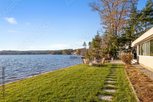 View of the lake from the lakefront home on a sunny day © Allan Wolf/Wirestock Creators