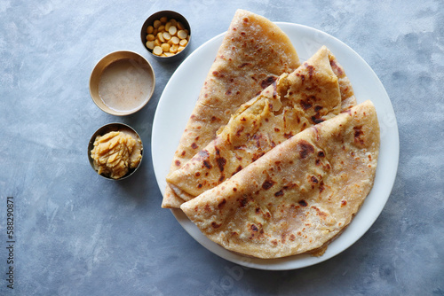 Puran Poli is an Indian sweet flatbread stuffed with chana dal, jaggery, ghee and cardamom and is usually eaten at Holi or Gudi Padva festival. Recipe ingredients. copy space. Healthy sweet dessert.  photo