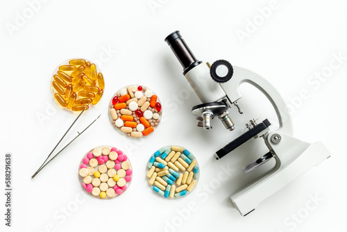 Biotechnology concept with medical drugs and microscope in the lab