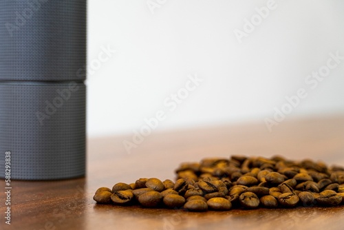 Coffee beans on a pile of ground coffee are close-ups. photo