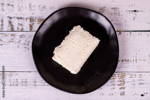 Clotted cream on wood background. Clotted cream (butter cream) for Turkish breakfast. local name inek kaymak. Top view photo