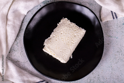 Clotted cream on gray background. Clotted cream (butter cream) for Turkish breakfast. local name inek kaymak. Top view photo