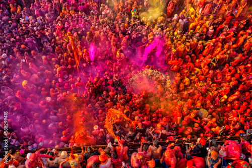 Nandgaon, India - 01 March 2023: Aerial view of people celebrating the holy colour festival at Shri And Baba Temple, Uttar Pradesh, India. photo