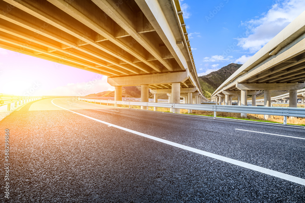 Asphalt road highway and viaduct with mountain background Asphalt road highway and viaduct with mountain background
