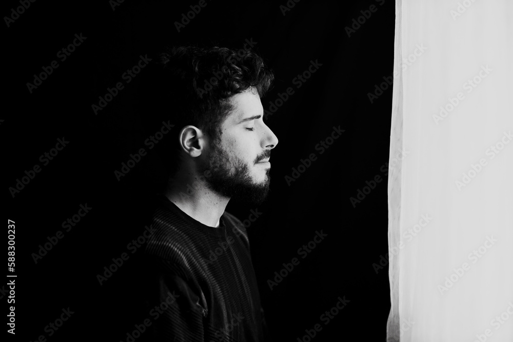 Man with eyes closed near wall Man with eyes closed near wall