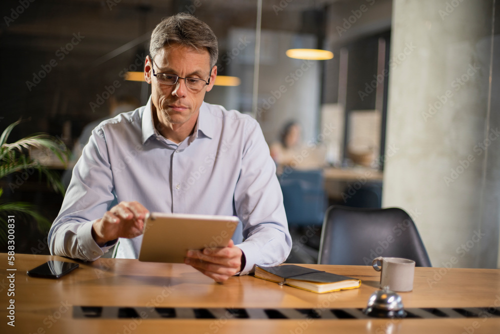 Portrait of businessman in office. Man using digital tablet. Businessman having video call Portrait of businessman in office. Man using digital tablet. Businessman having video call