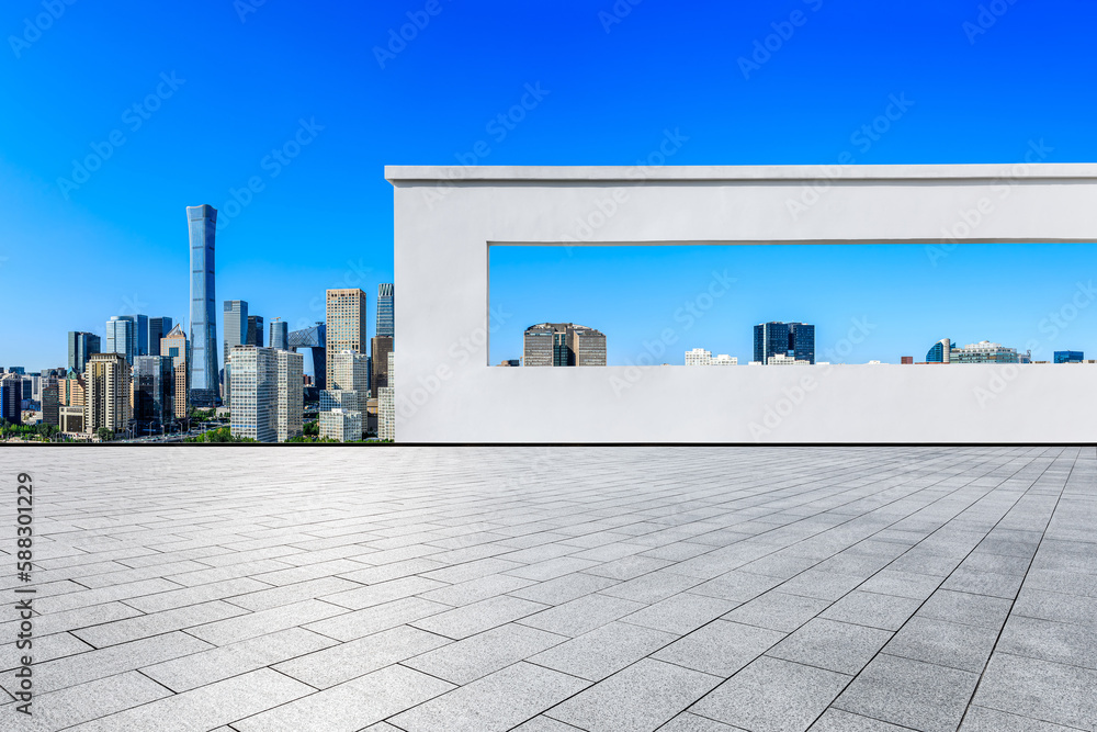 Empty square floors and wall with city skyline in Beijing, China.